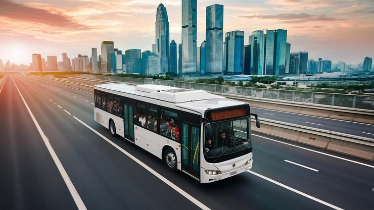 White city bus traveling on highway, top view – Bus Rental Ajman