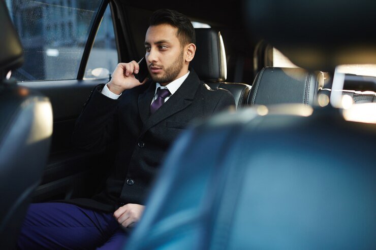 a businessman at phone call for enjoy journey of coporate transportation in umm al quwain