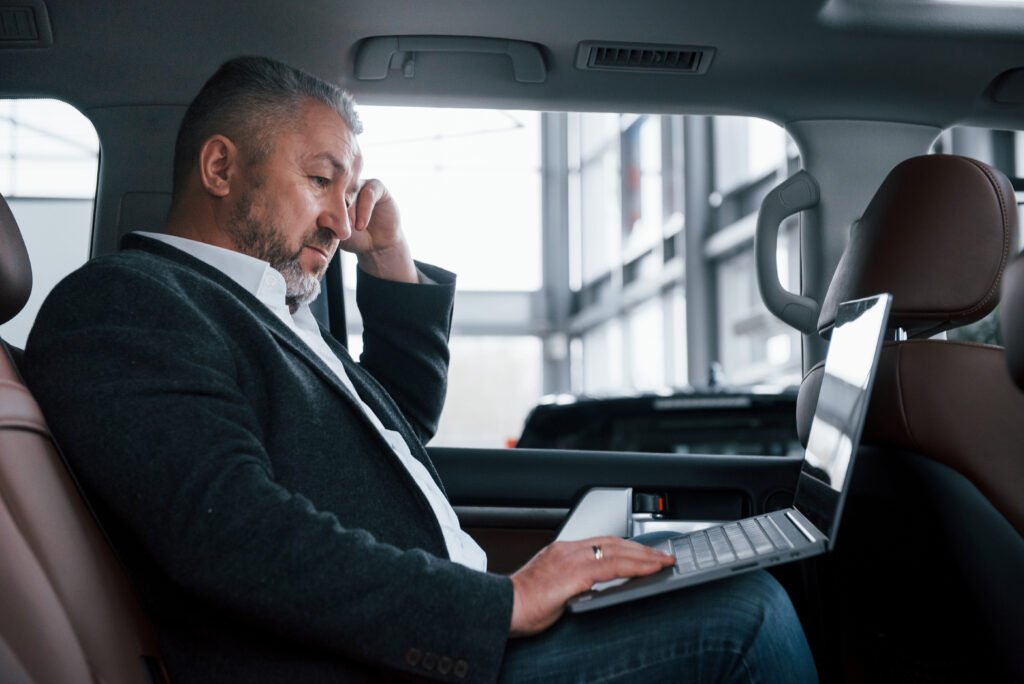 a business man busy in car for join meeting for corporate transportation in sharjah